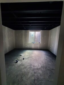 Basement ceiling coated with dryfall.