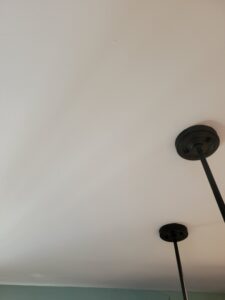 Repaired drywall, primed, textured, and finished with 2 coats of Super Paint.