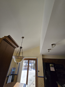 Performed ceiling drywall repair, added a sand texture for a uniform appearance, and applied two coats of premium Super Paint.
