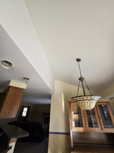 Ceiling drywall repaired, finished with a consistent sand texture, and coated with two layers of high-quality Super Paint.