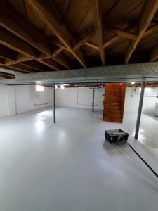 Drylok on walls, Armorseal on floor, enamel on beams – 2 coats each for a strong, lasting finish.