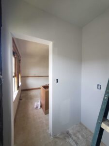 Framed, installed drywall, and applied primer in kitchen.