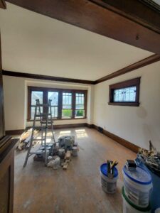 Plaster walls restored with repairs, skim coat, and 2 coats of primer.